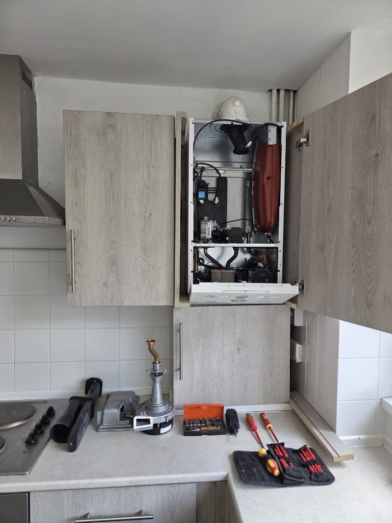 Open domestic boiler casing for servicing and safety checks in Torbay
