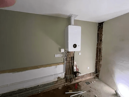 Domestic boiler installation with exposed copper pipework in Torbay