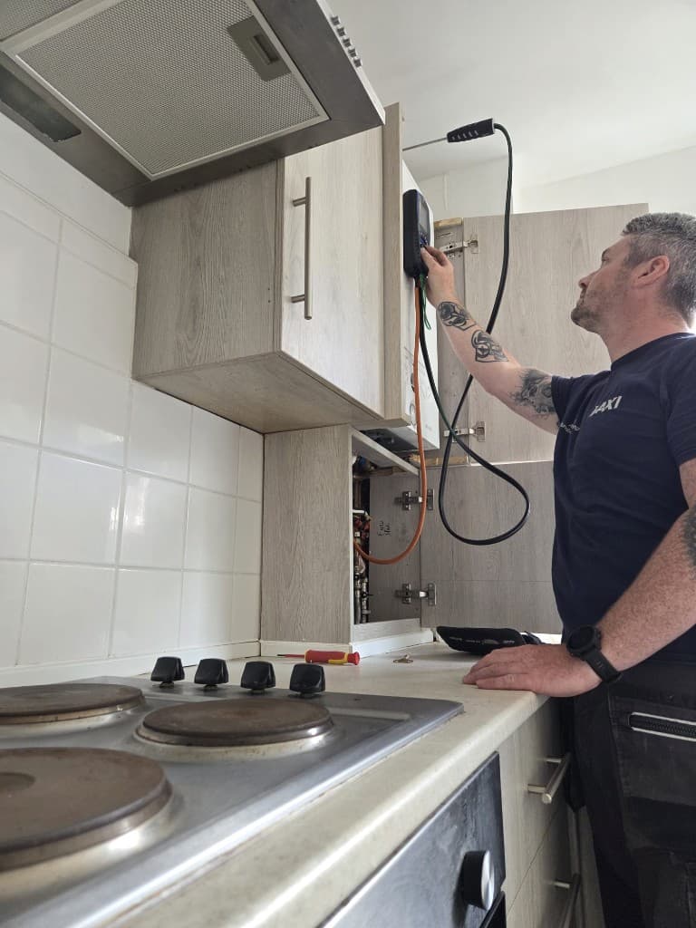 Gas engineer carrying out domestic boiler servicing in Paignton