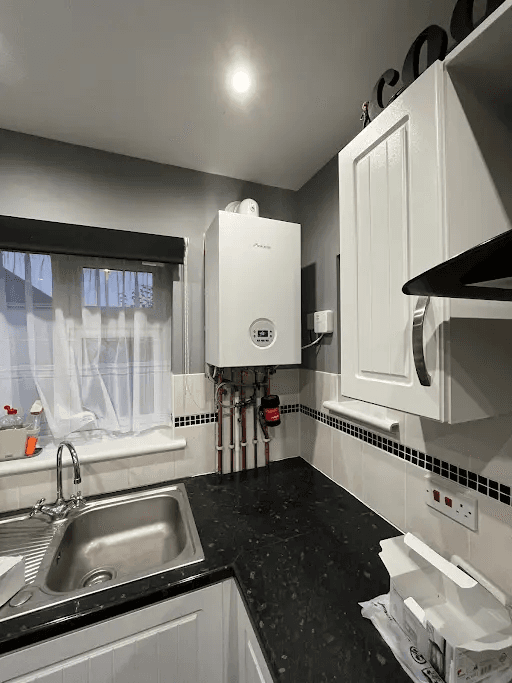 Domestic kitchen boiler installation with tidy pipework in Torbay